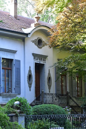a white house with a black gate