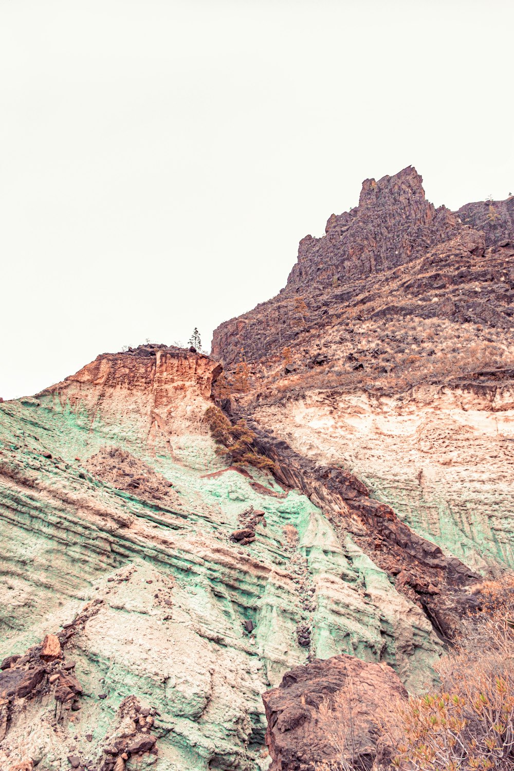 a rocky cliff with a valley below