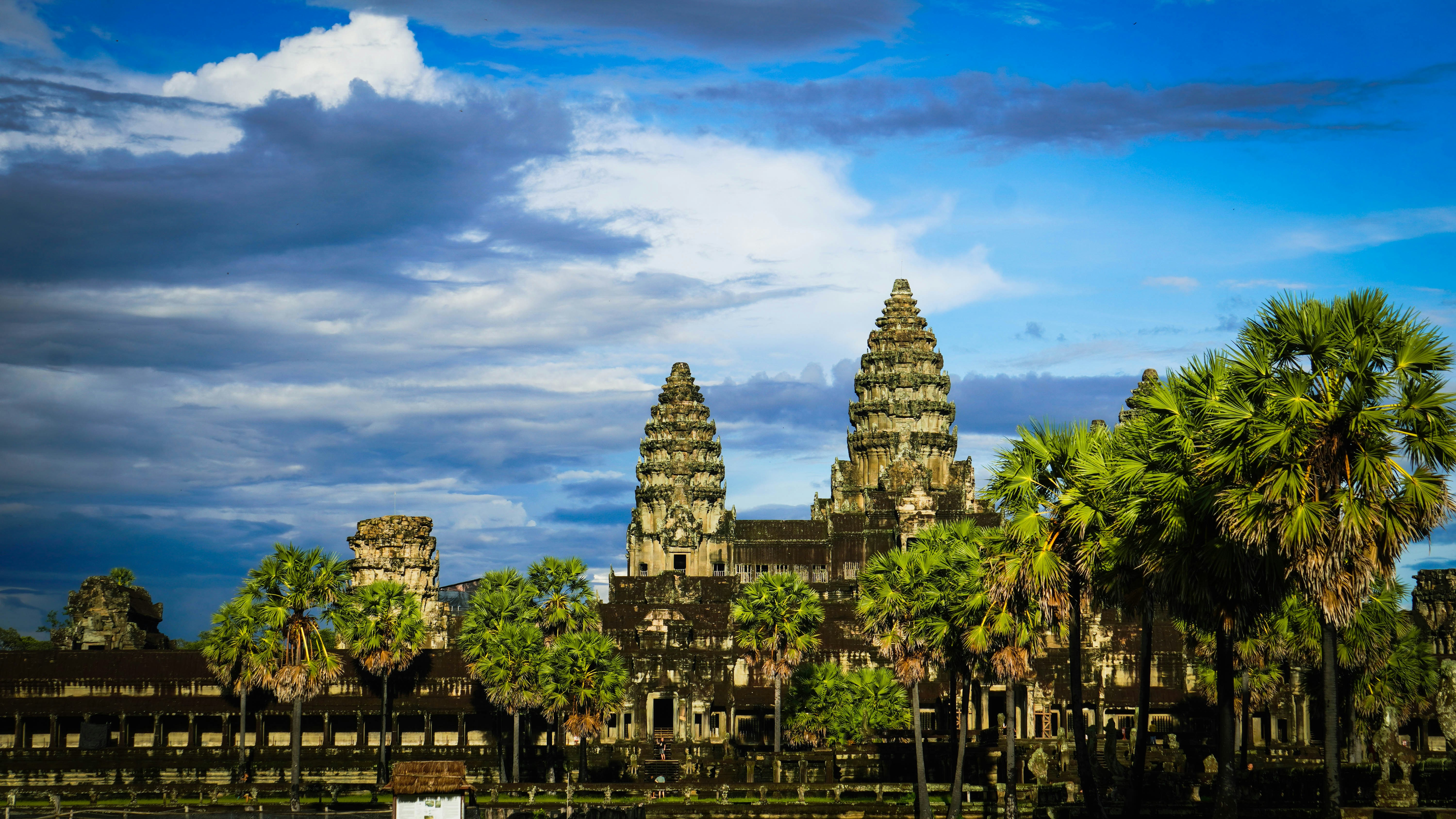 a building with towers and trees, Angkor Wat temple