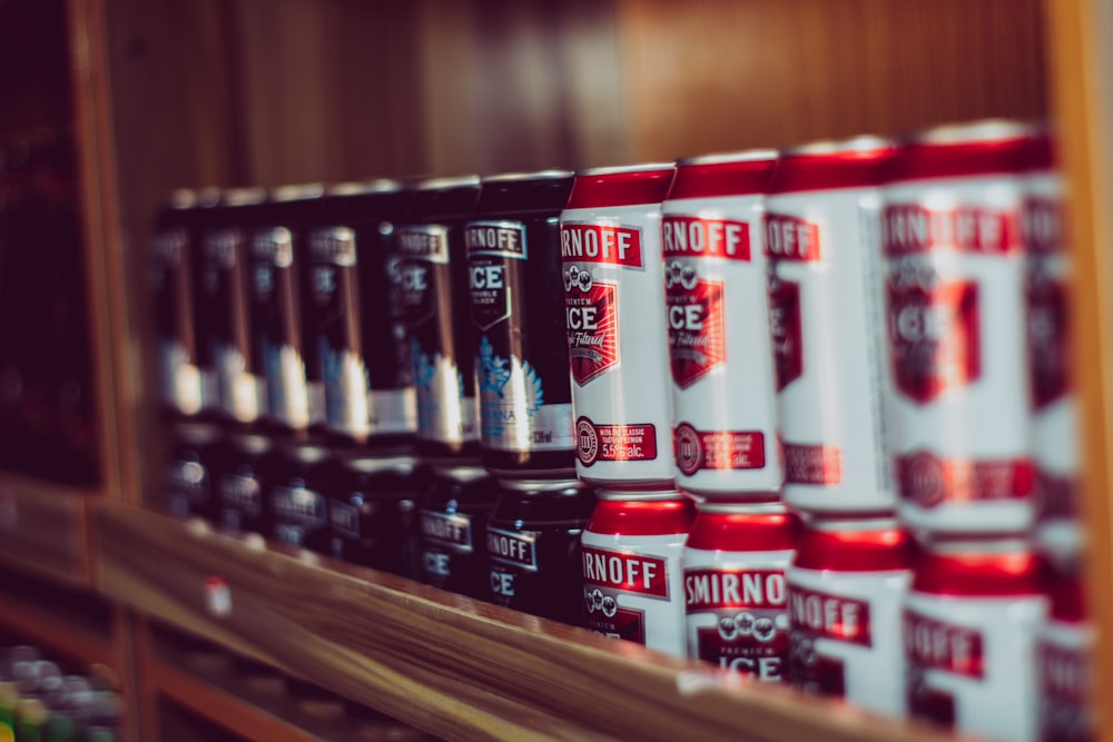 a shelf with many cans of soda on it