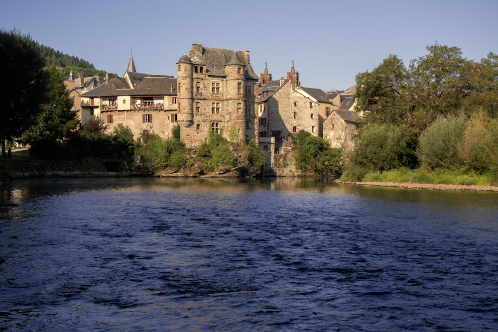 a large building on a hill by a body of water