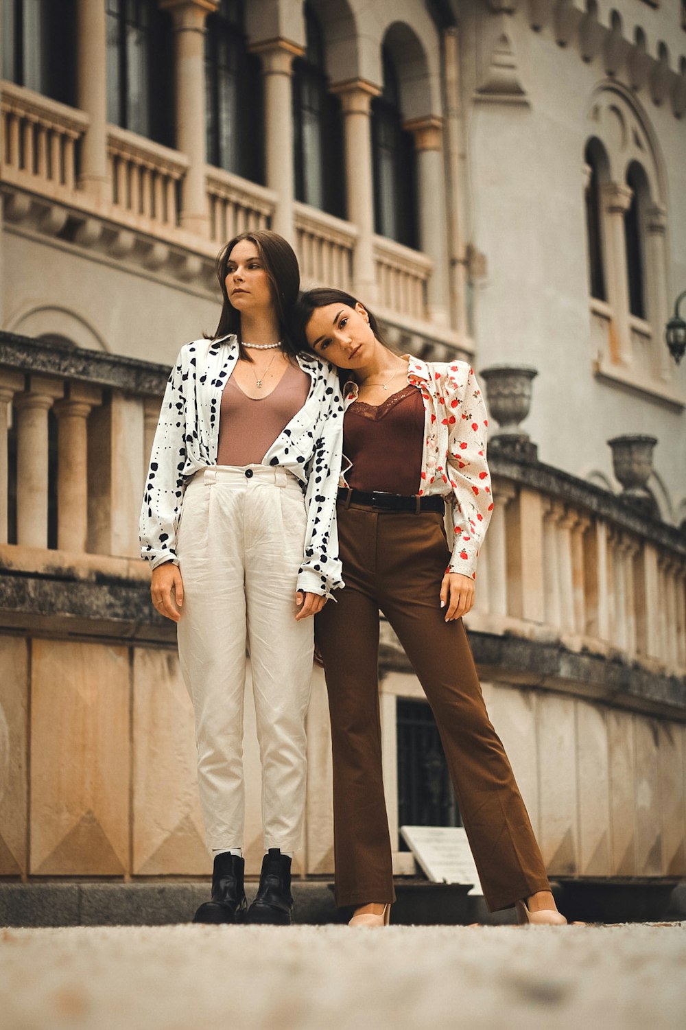 a man and woman posing for a picture in front of a building