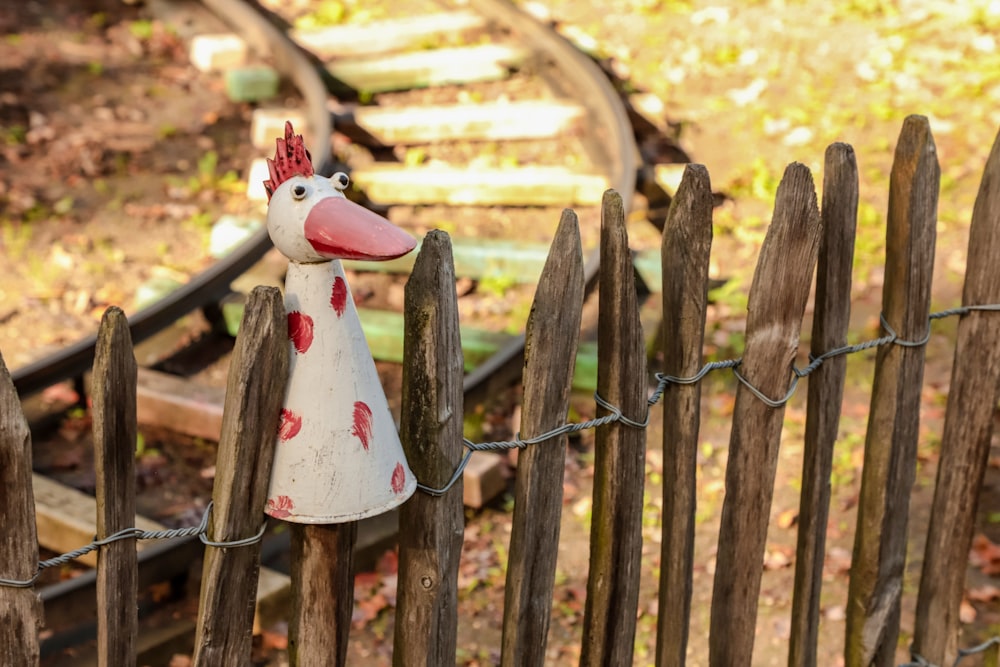 a wooden fence with a toy horse