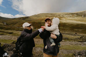 Parents and kids sharing a cozy picnic with mountain views in the background