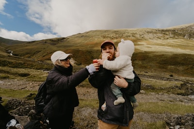 A family smiling during a scenic mountain hike in Turkey.