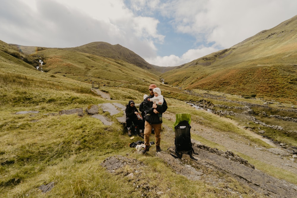 a group of people sitting on a rock with a dog