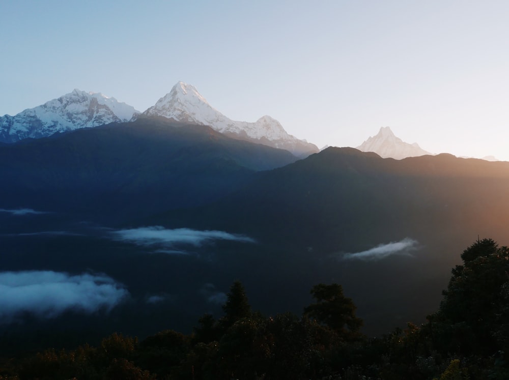 a mountain range with clouds below