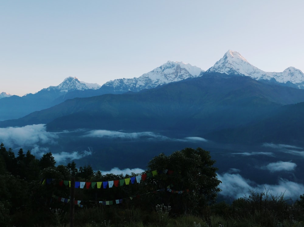 a mountain range with clouds below