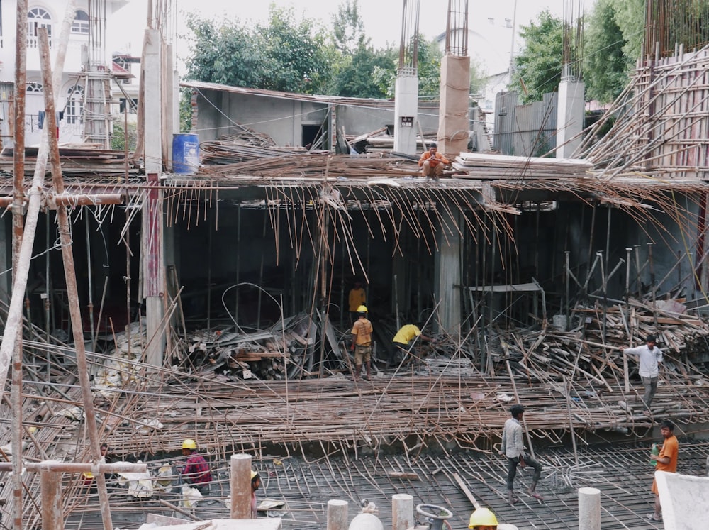 a group of people standing next to a building that is falling apart