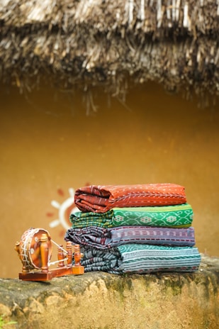a pair of colorful shoes on a rock by a river