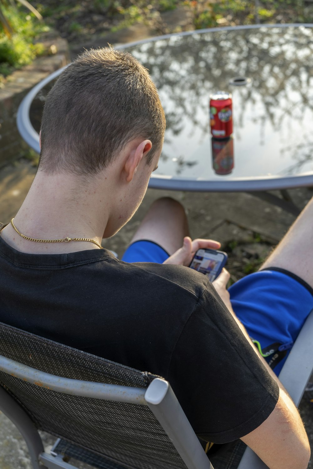 a man sitting in a chair with a soda can