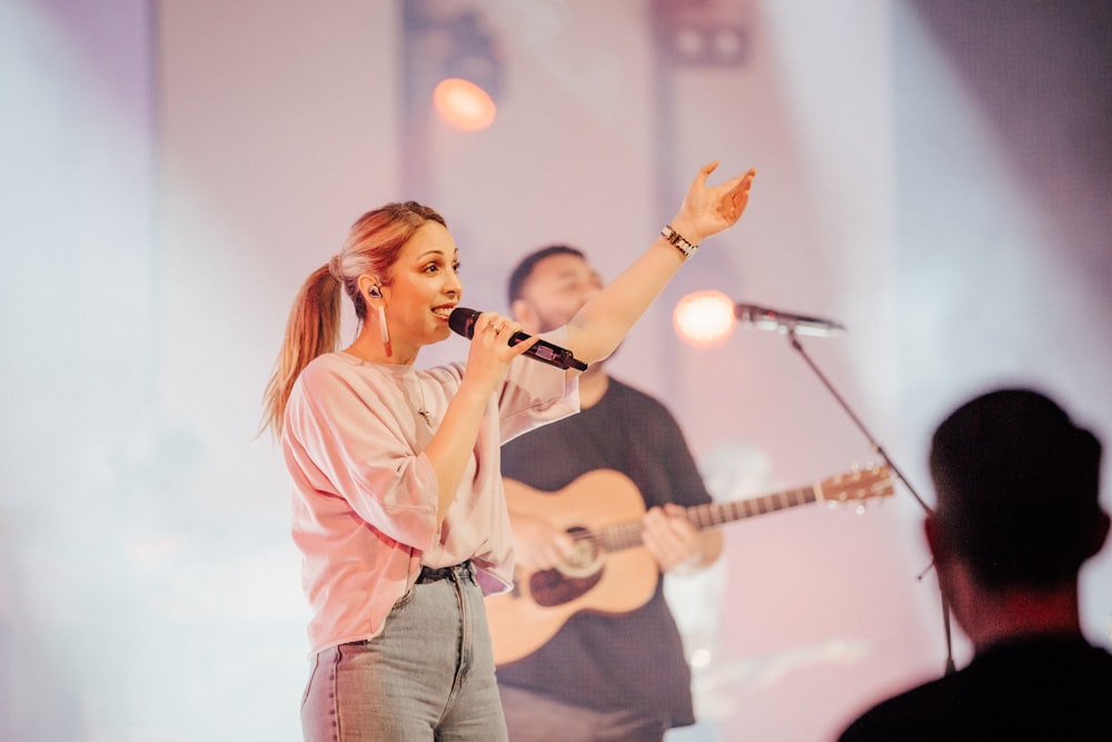 a person singing into a microphone