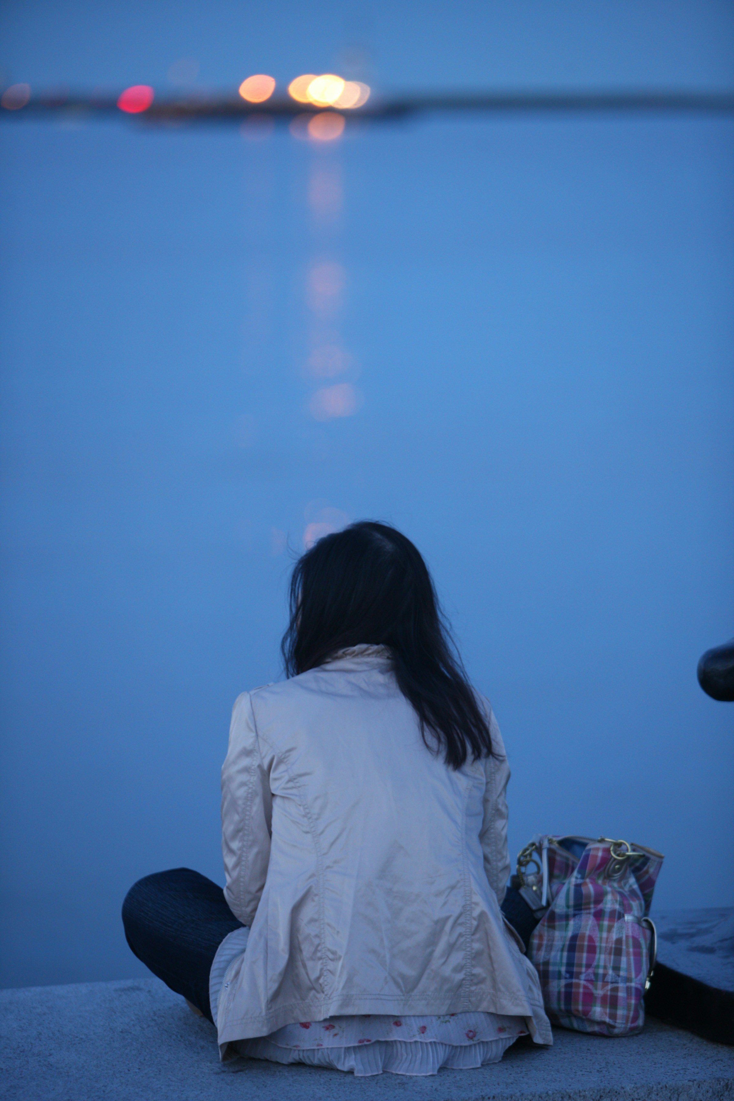 a person sitting on a couch looking at a light