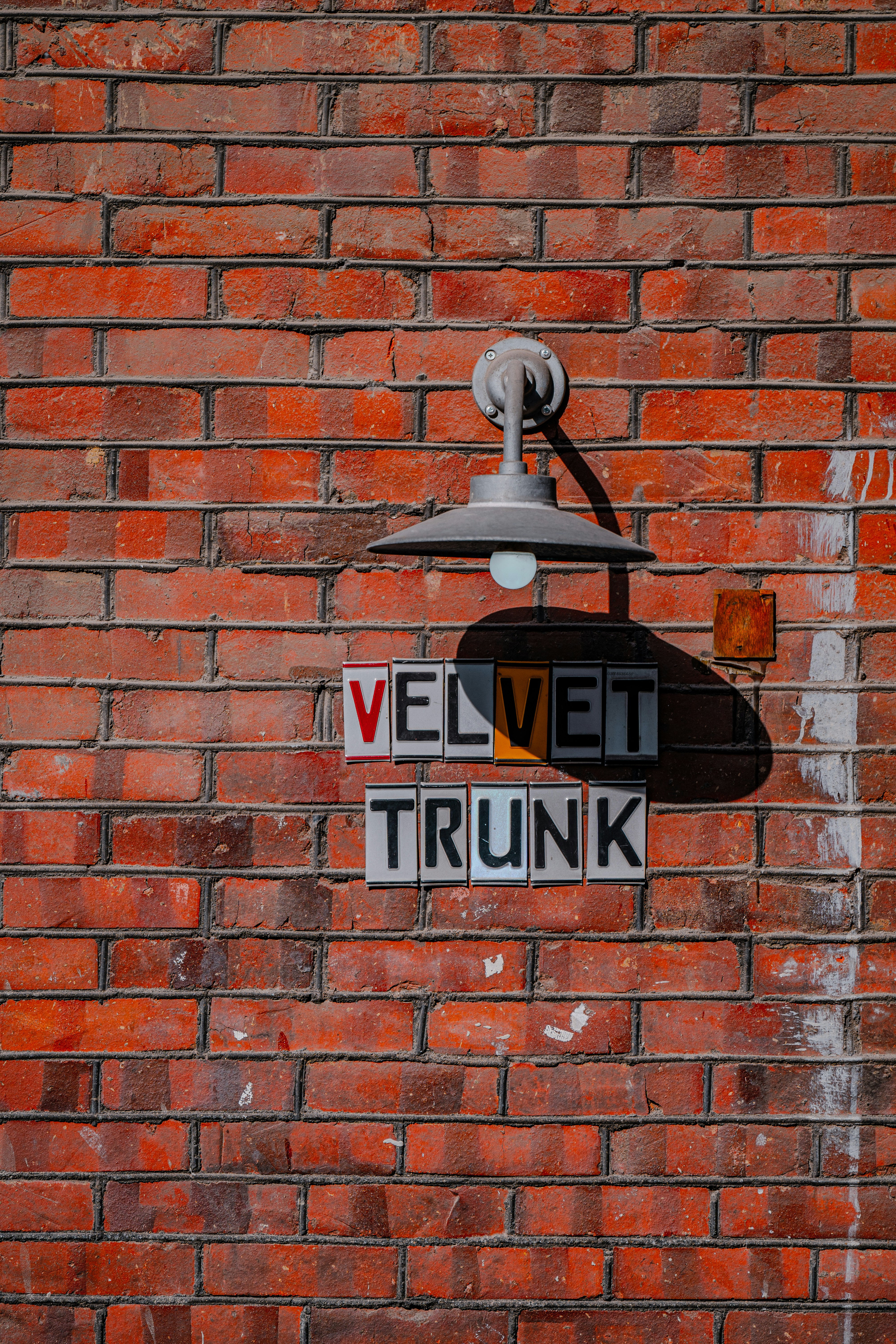 A sign on a brick wall photo – Free Brick Image on Unsplash