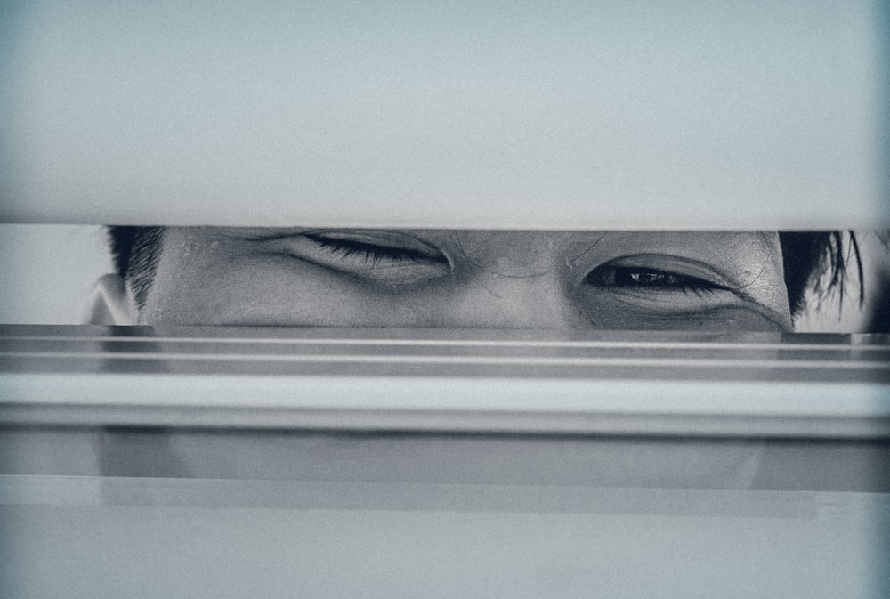 a person's face on a shelf
