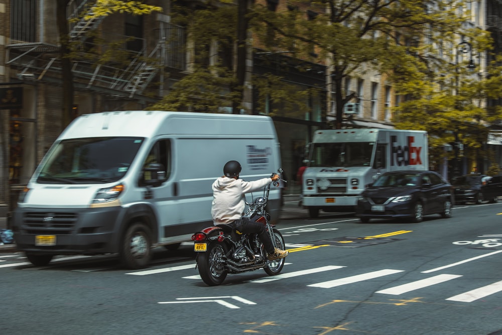 a person riding a motorcycle down the street