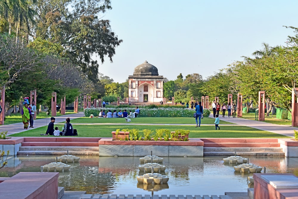 a group of people sitting on a bench in a park