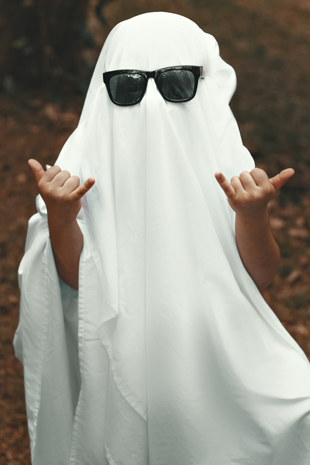 a person wearing a white robe and sunglasses