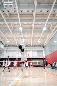 A vibrant volleyball court scene with players diving and spiking under bright sunlight.