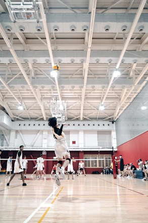 Volleyball coach giving tips to players during an intense training session.