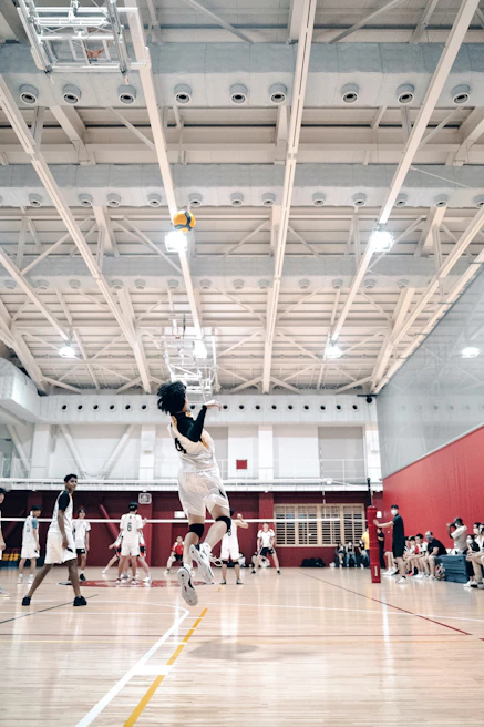Action shot of a player executing a powerful spike during a match at Palamaggiore Leinì.