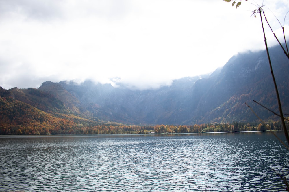 a body of water with mountains in the background