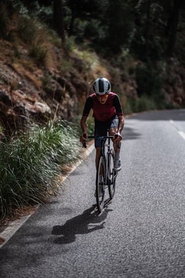 a man riding a bicycle on a road