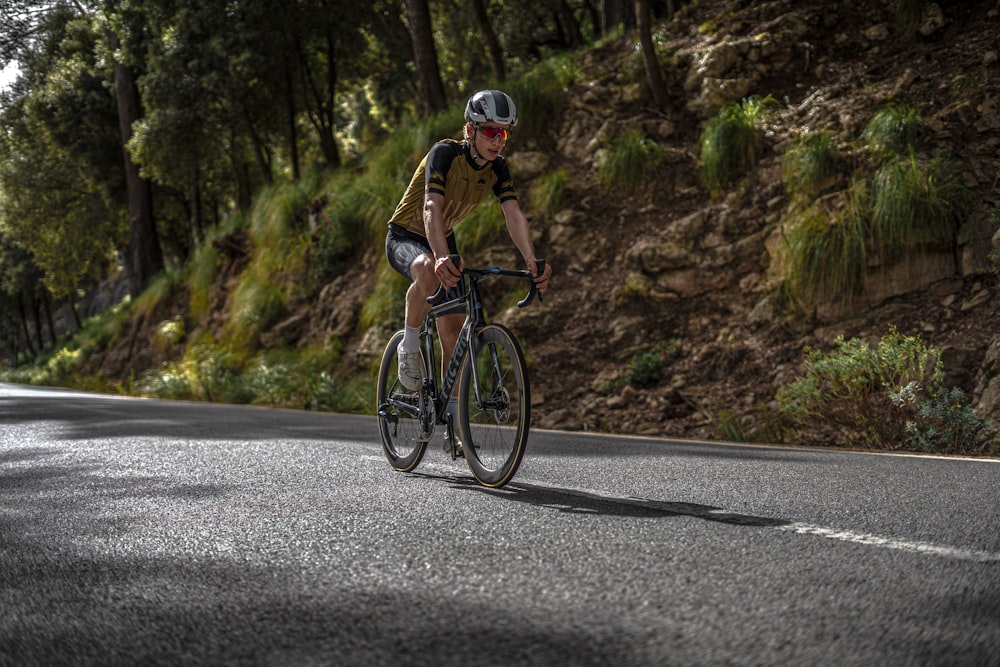 a man riding a bicycle on a road