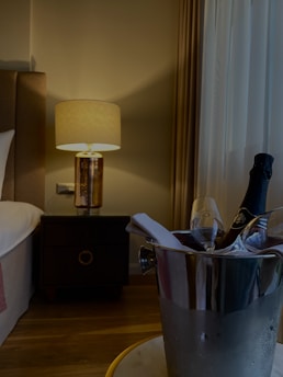 A serene night scene with a glowing jar of night cream on a bedside table surrounded by soft candlelight.
