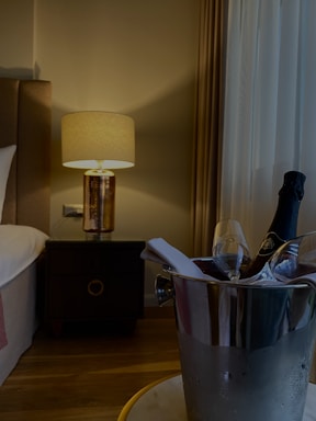 A cozy bedroom scene with soft lighting and a bottle of sleep supplements on the nightstand