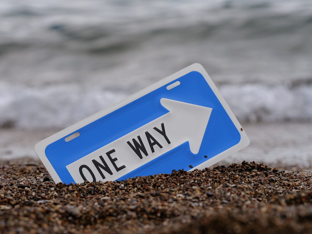 a blue sign on a beach