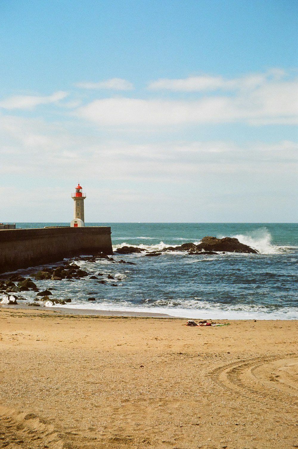 a lighthouse on a rocky beach