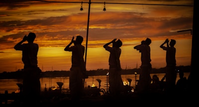 silhouette of people standing on a beach