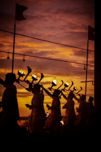 silhouette of people holding flags