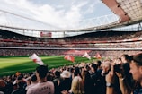 A panoramic view of a bustling sports stadium in Saudi Arabia filled with cheering fans.