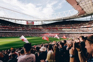 A panoramic view of a bustling sports stadium in Saudi Arabia filled with cheering fans.