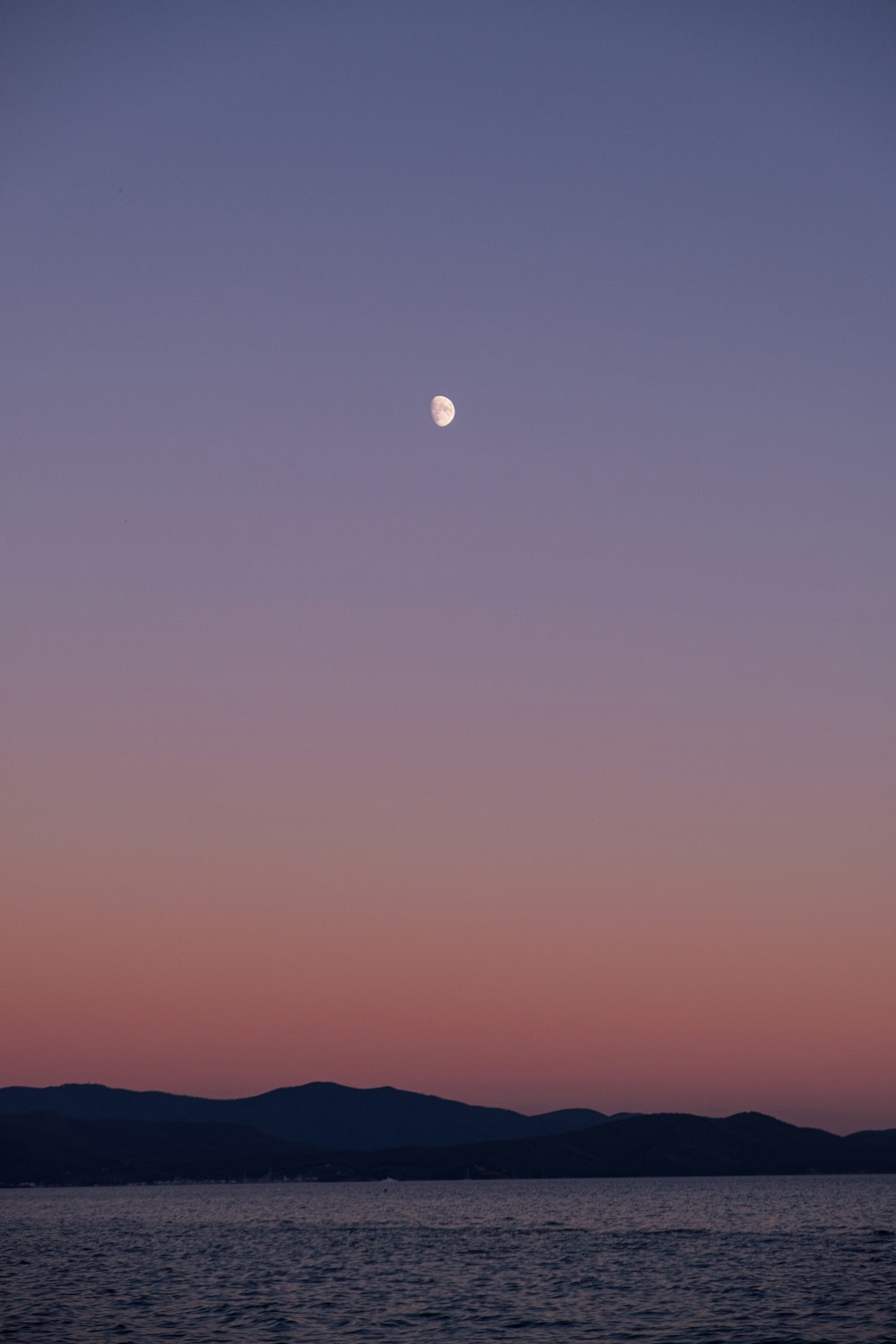 a moon over a body of water