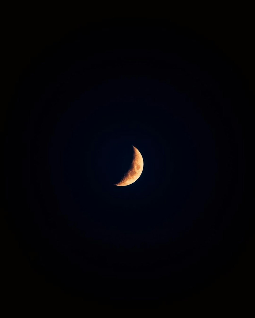 a crescent moon in a black sky