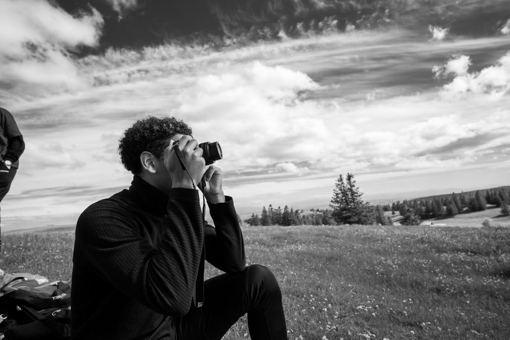 a man taking a picture of a mountain range