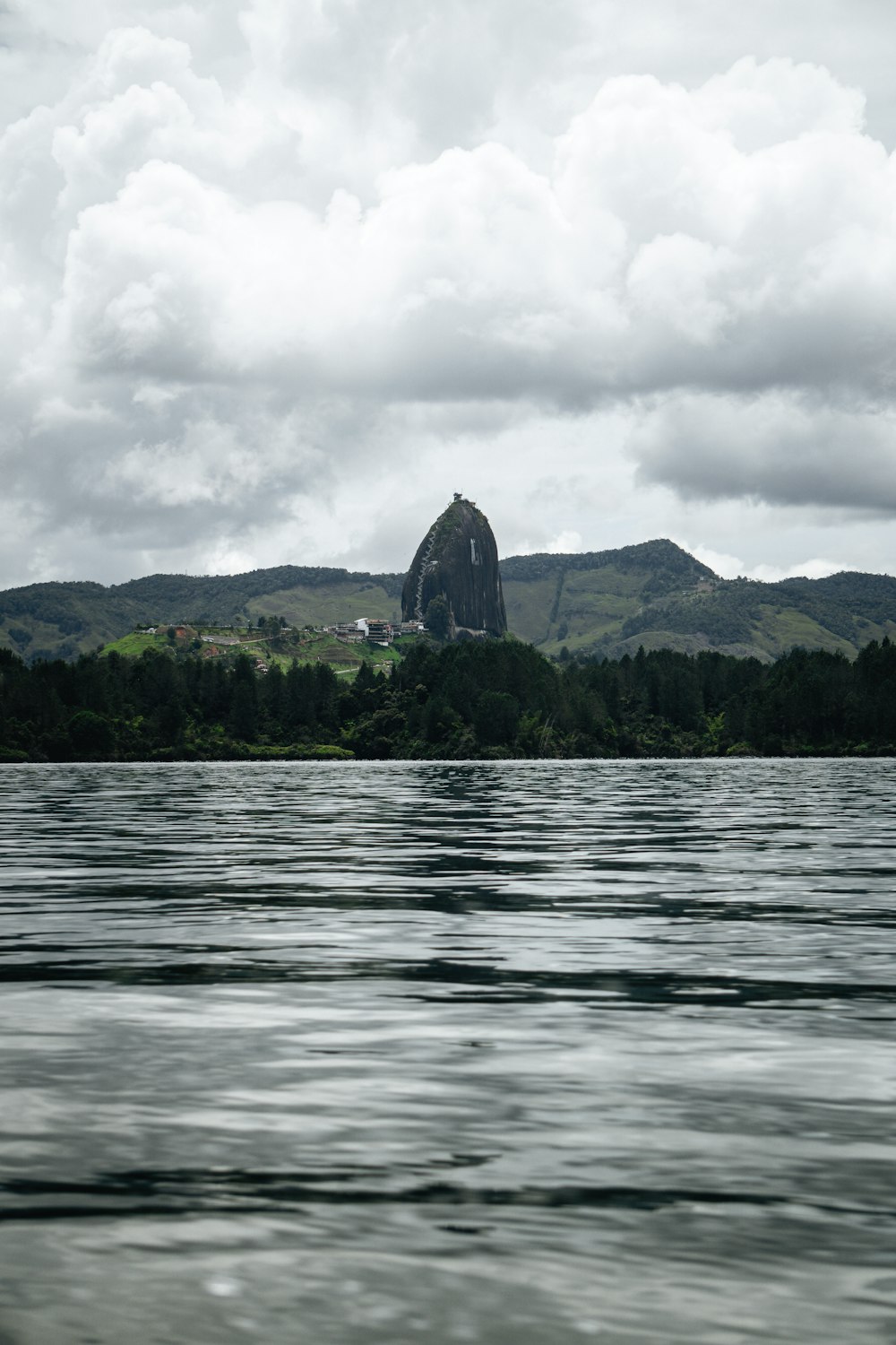 a body of water with a mountain in the background