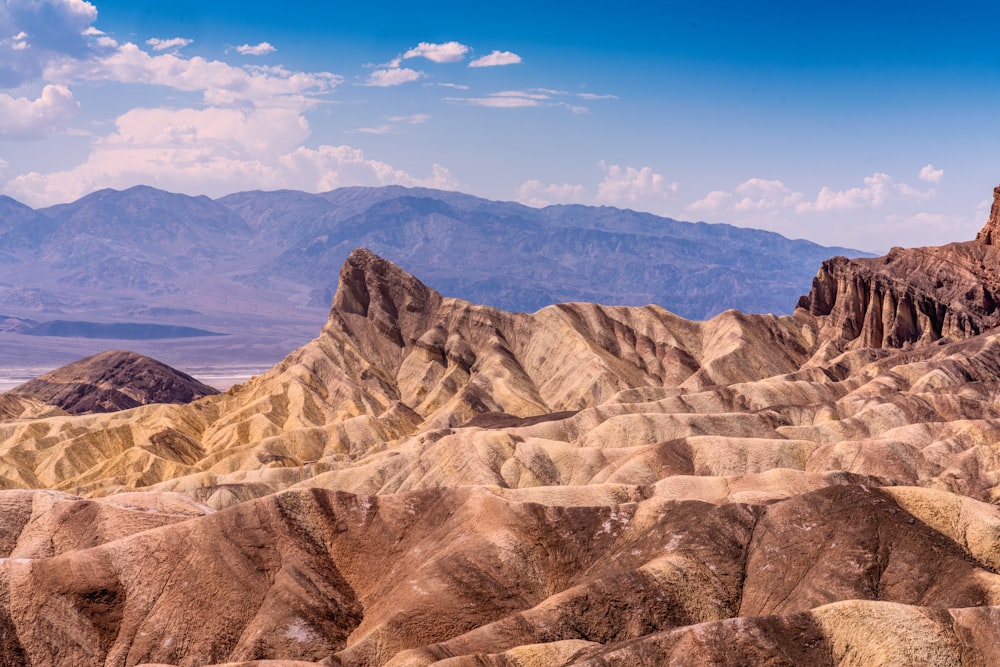 a rocky landscape with mountains in the background