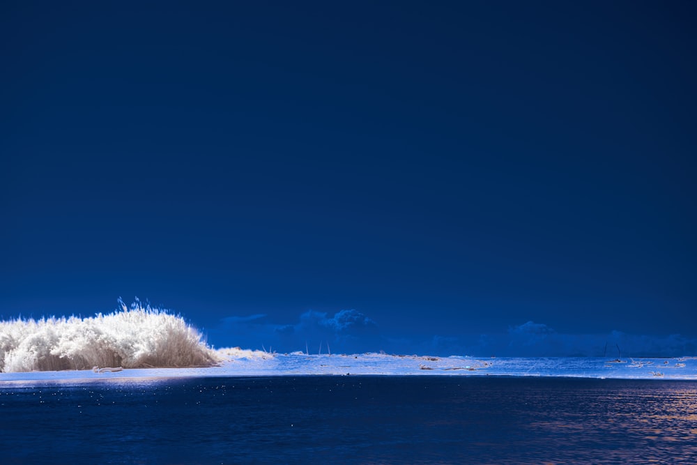 a body of water with snow on the side