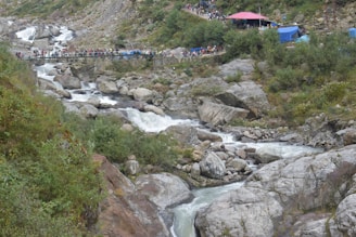 Colorful tents and eco-lodges nestled beside the river, with adventurers relaxing after a day of thrills