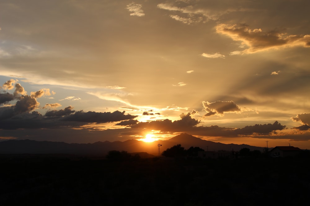 a sunset over a field