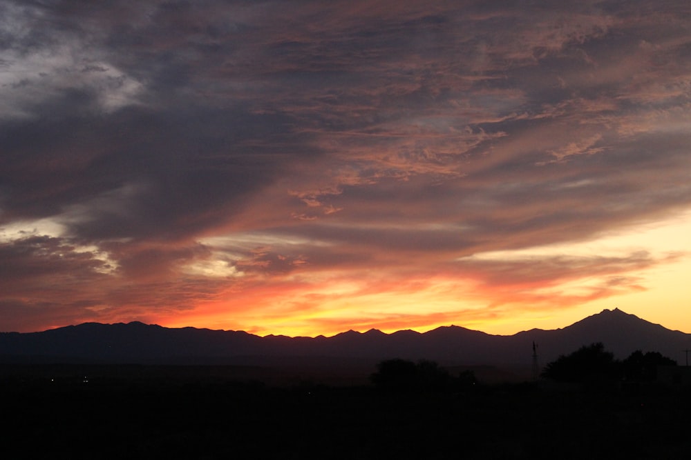 a sunset over a mountain range