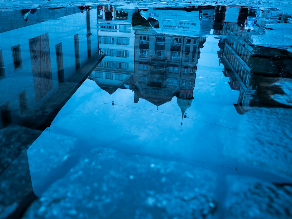 a large building with a pool of water in front of it