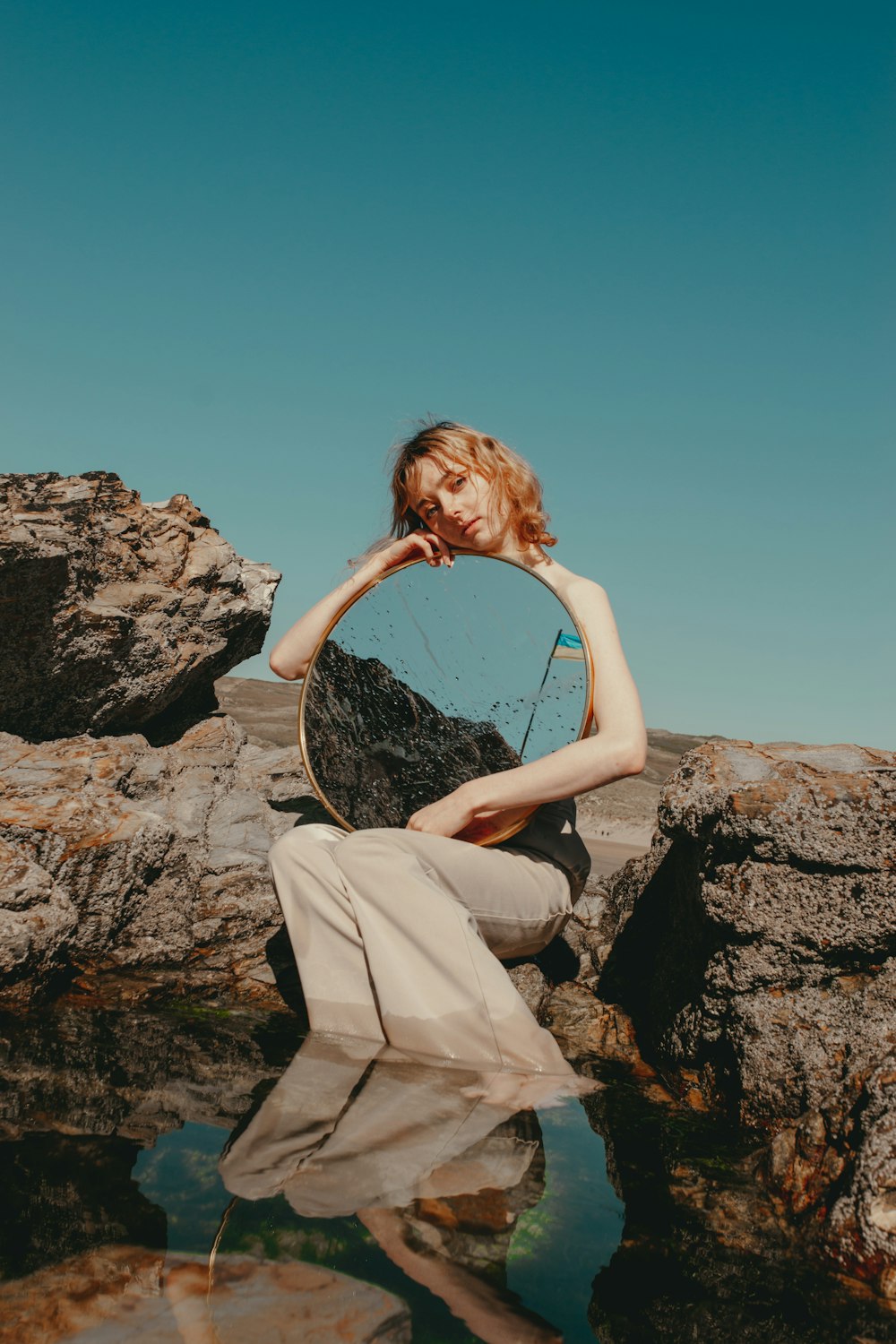 a person sitting on a rock