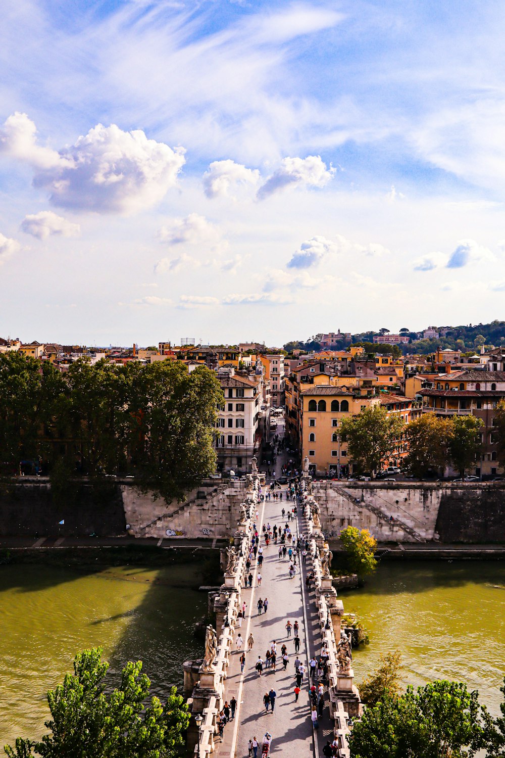 a river with a bridge and buildings along it