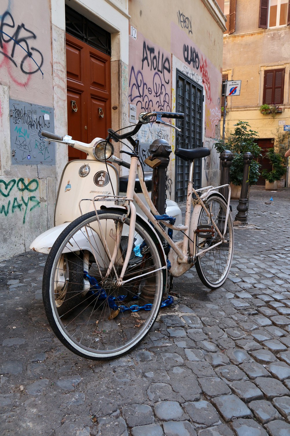 a bicycle parked on a cobblestone street