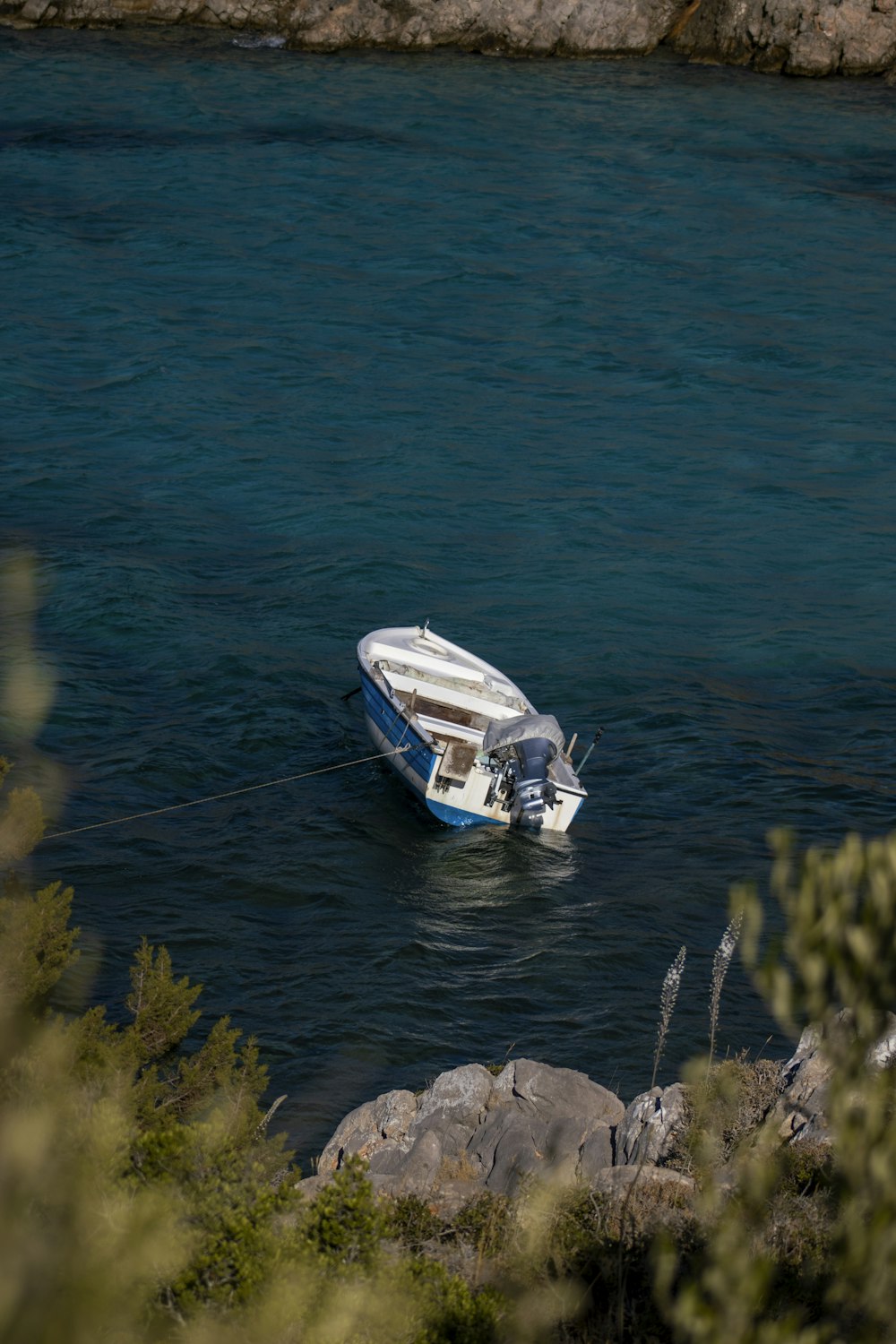 a boat is tied to a rock